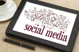 iPad with social media words on a table next to coffee cup